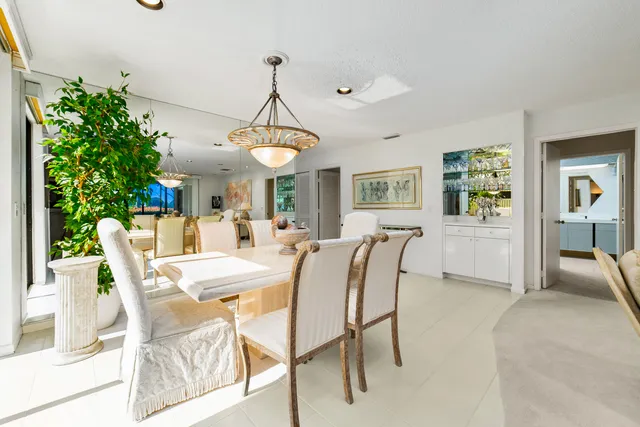 a dining room with furniture and a floor to ceiling window