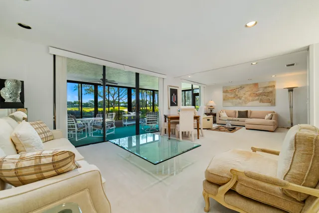 a view of a garden with plants and wooden fence