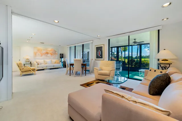 a view of a chairs and table in the backyard with plants