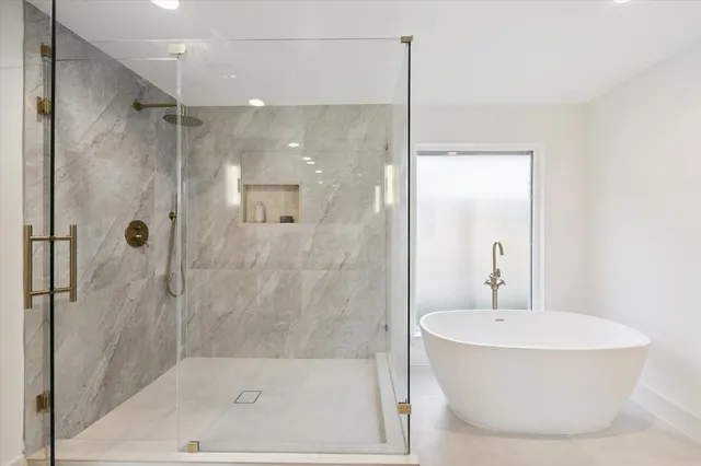 a bathroom with a bathtub and shower