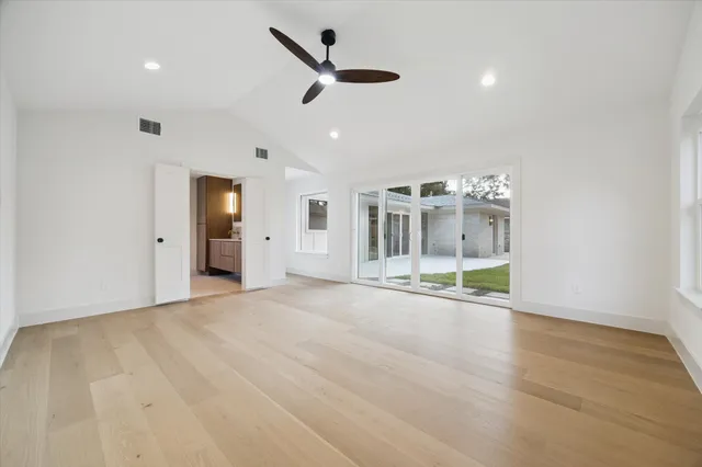 a view of a livingroom with a ceiling fan and window