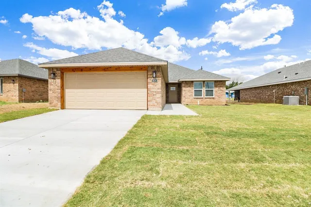 a view of a house with a yard and garage