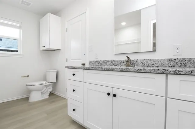 a bathroom with a sink toilet and mirror