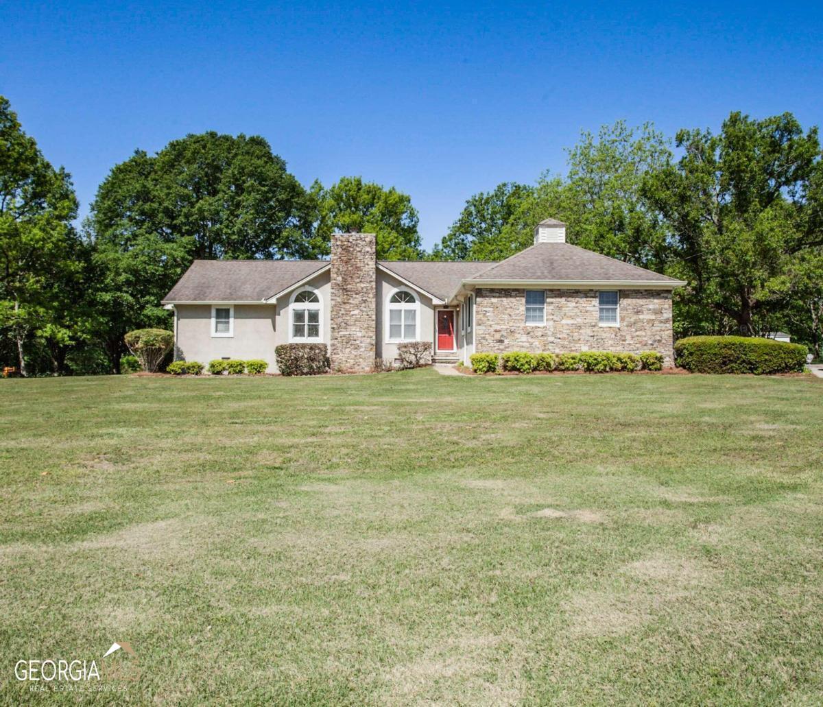 123 Dixon Road Bowdon, GA 30108 - Photo 1 of 1 a white house with a big yard and large trees