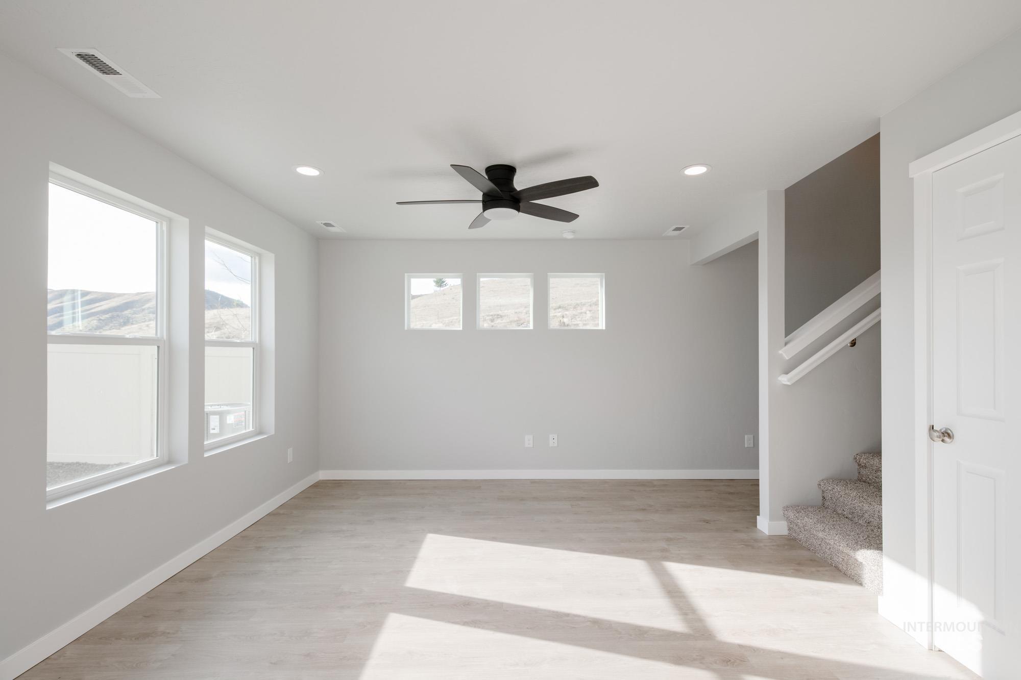 229 Moose Street Horseshoe Bend, ID 83629 - Photo 10 of 27 Spare room featuring ceiling fan, light wood finished floors, stairway, and recessed lighting
