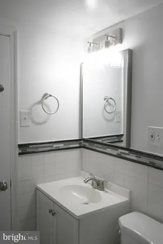 an empty room with a window and a ceiling fan