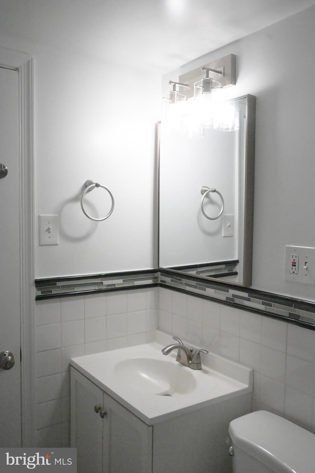9451 Fairfax Boulevard, Unit 102 Fairfax, VA 22031 - Photo 11 of 26 a bathroom with a sink and mirror