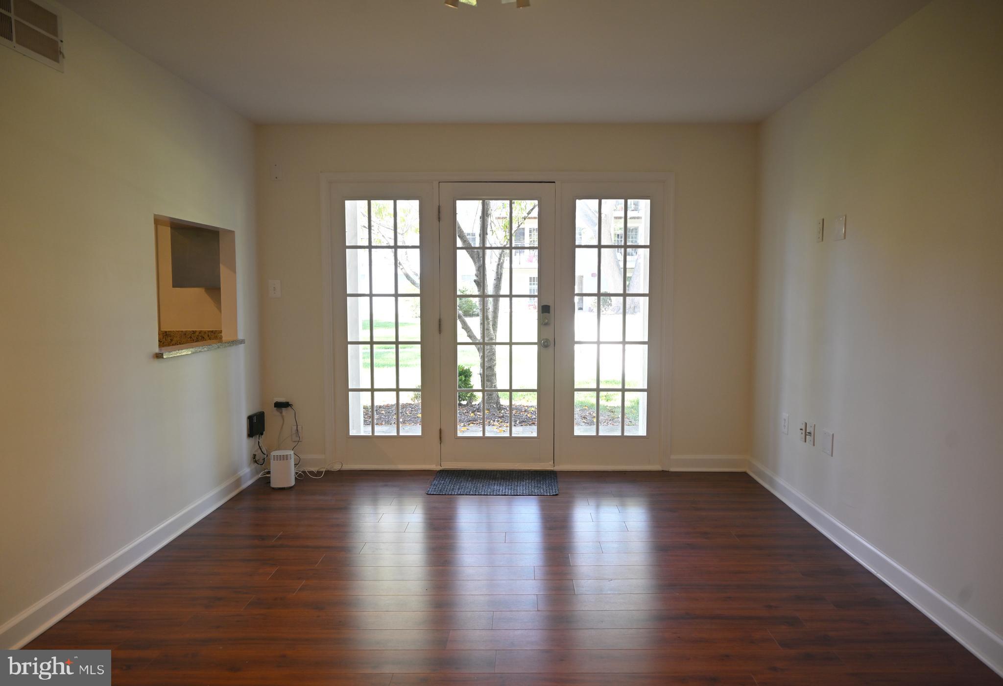 9451 Fairfax Boulevard, Unit 102 Fairfax, VA 22031 - Photo 2 of 26 wooden floor in an empty room with a window