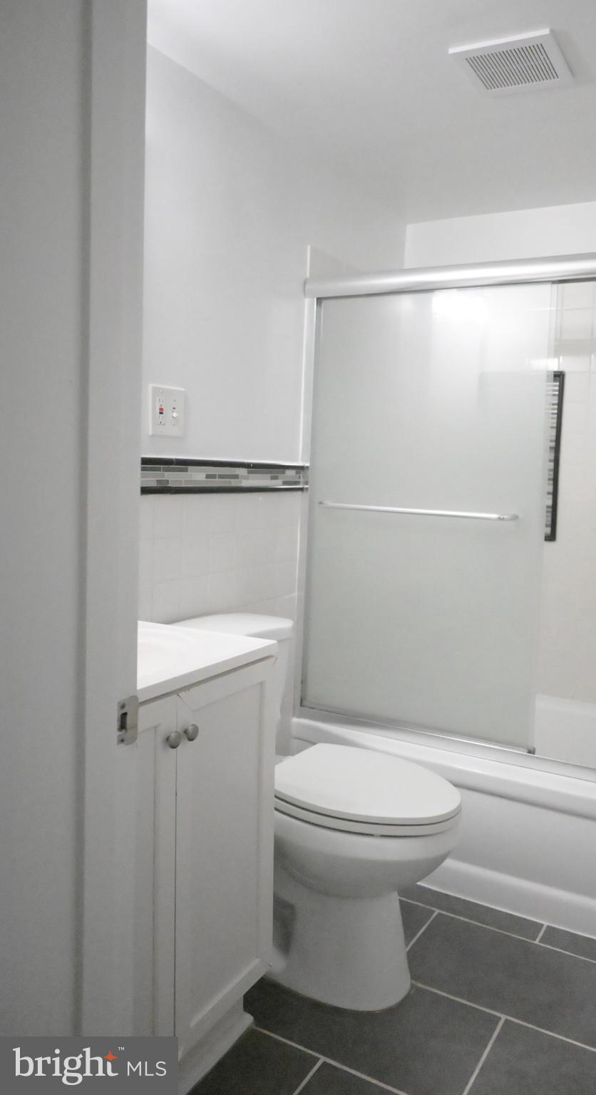 9451 Fairfax Boulevard, Unit 102 Fairfax, VA 22031 - Photo 9 of 26 a bathroom with a toilet and a shower