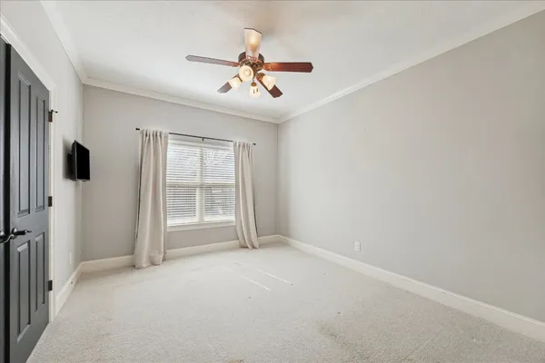 a view of a livingroom with a ceiling fan and window