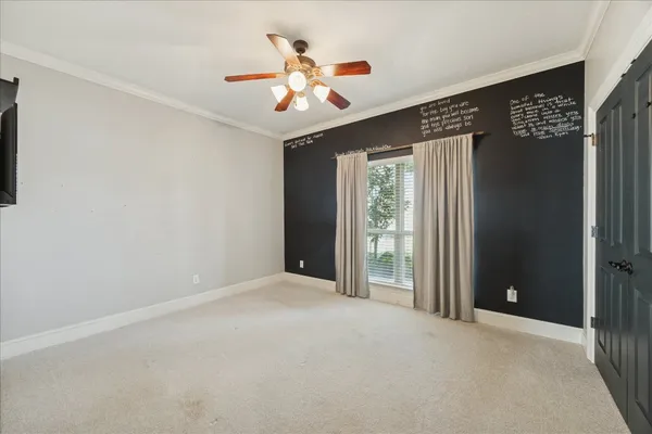 a view of a livingroom with a ceiling fan and window