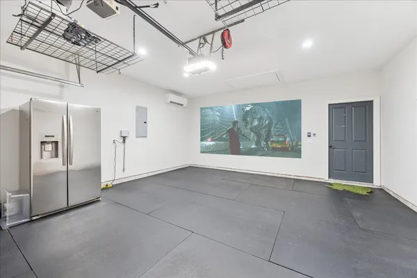 a view of entryway with cabinet and refrigerator