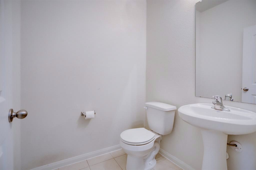 1303 Emerald Stone Drive Rosharon, TX 77583 - Photo 16 of 25 Well-positioned powder bath on the main level offering added convenience for entertaining.