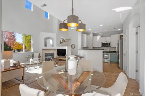 a living room with fireplace furniture and a chandelier