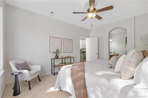 a bed room with a bed and a chair