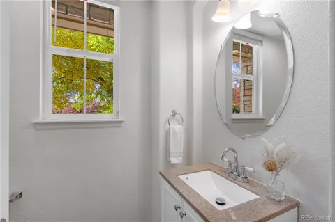 a bathroom with a sink a mirror and a window