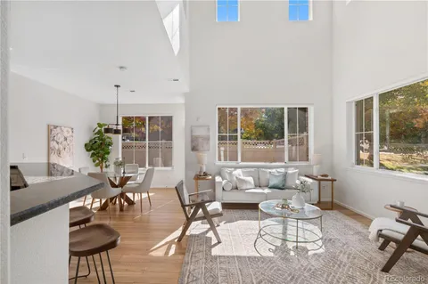 a living room with furniture and floor to ceiling windows