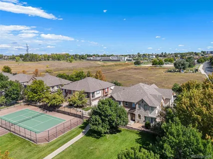 an aerial view of a house with garden space and outdoor seating