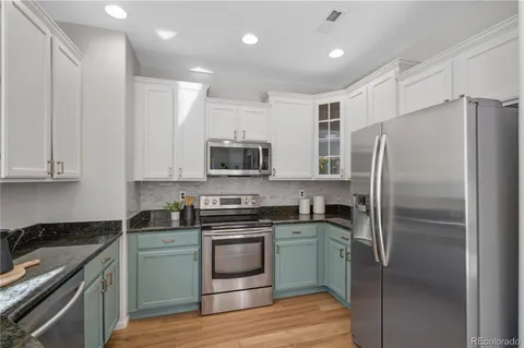a kitchen with stainless steel appliances cabinets a sink and a stove