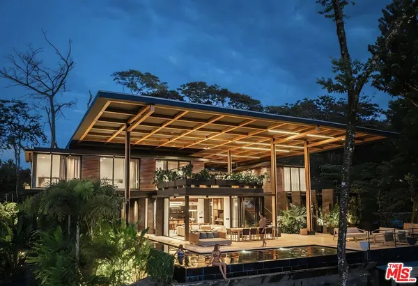 a view of house with swimming pool and outdoor seating