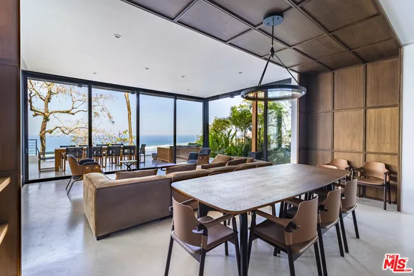 a living room with furniture and a floor to ceiling window