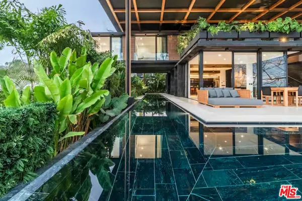a backyard of a house with lots of green space and outdoor seating