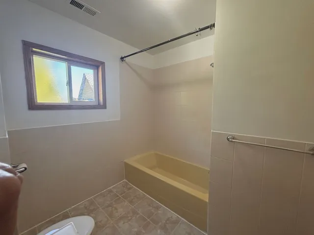 a bathroom with a tub and a shower