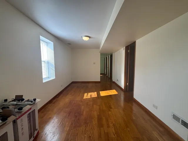 a view of a room with wooden floor