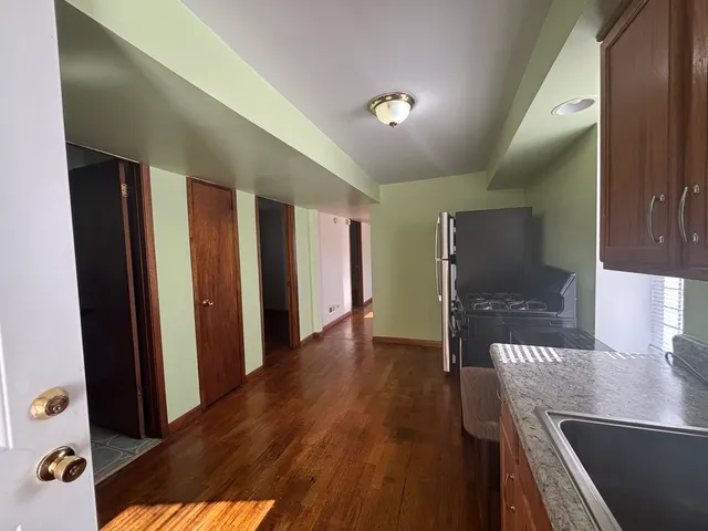 a view of hallway with furniture and wooden floor
