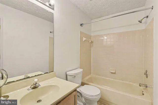 a bathroom with a sink mirror toilet and bathtub