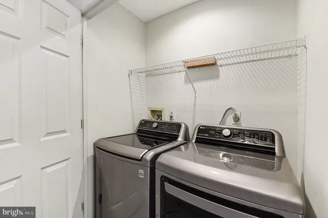 a view of storage and utility room with washer and dryer