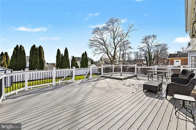 a view of roof deck with chairs and wooden floor