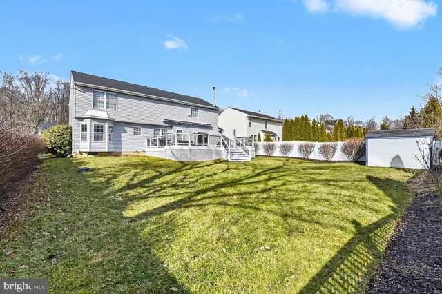 a swimming pool with trees in front of it