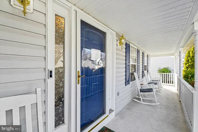 a balcony with furniture and a potted plant