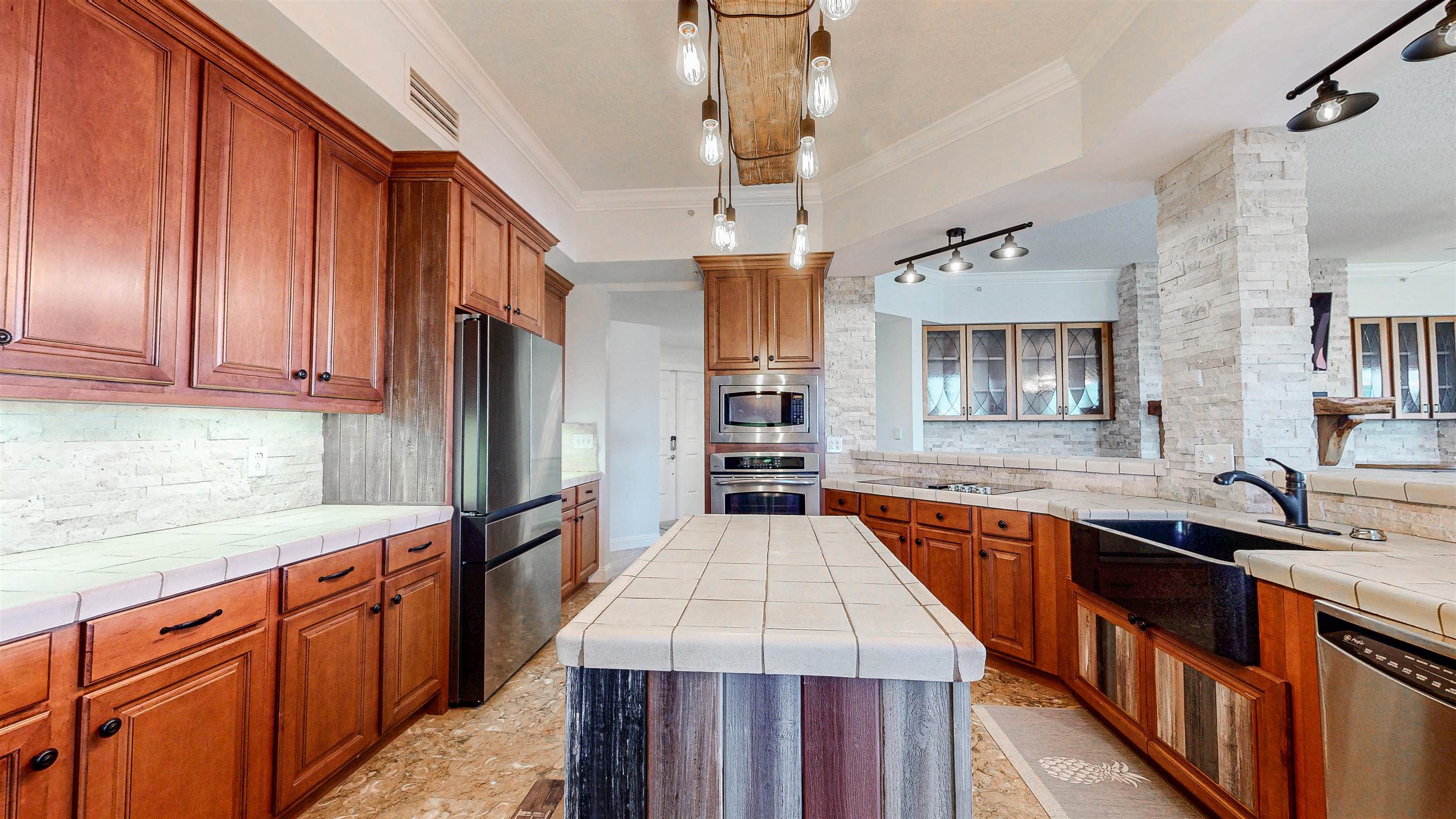 115 Sunset Harbor Way, Unit 303 St. Augustine, FL 32080 - Photo 18 of 76 a kitchen with stainless steel appliances granite countertop a sink dishwasher a refrigerator and cabinets with wooden floor