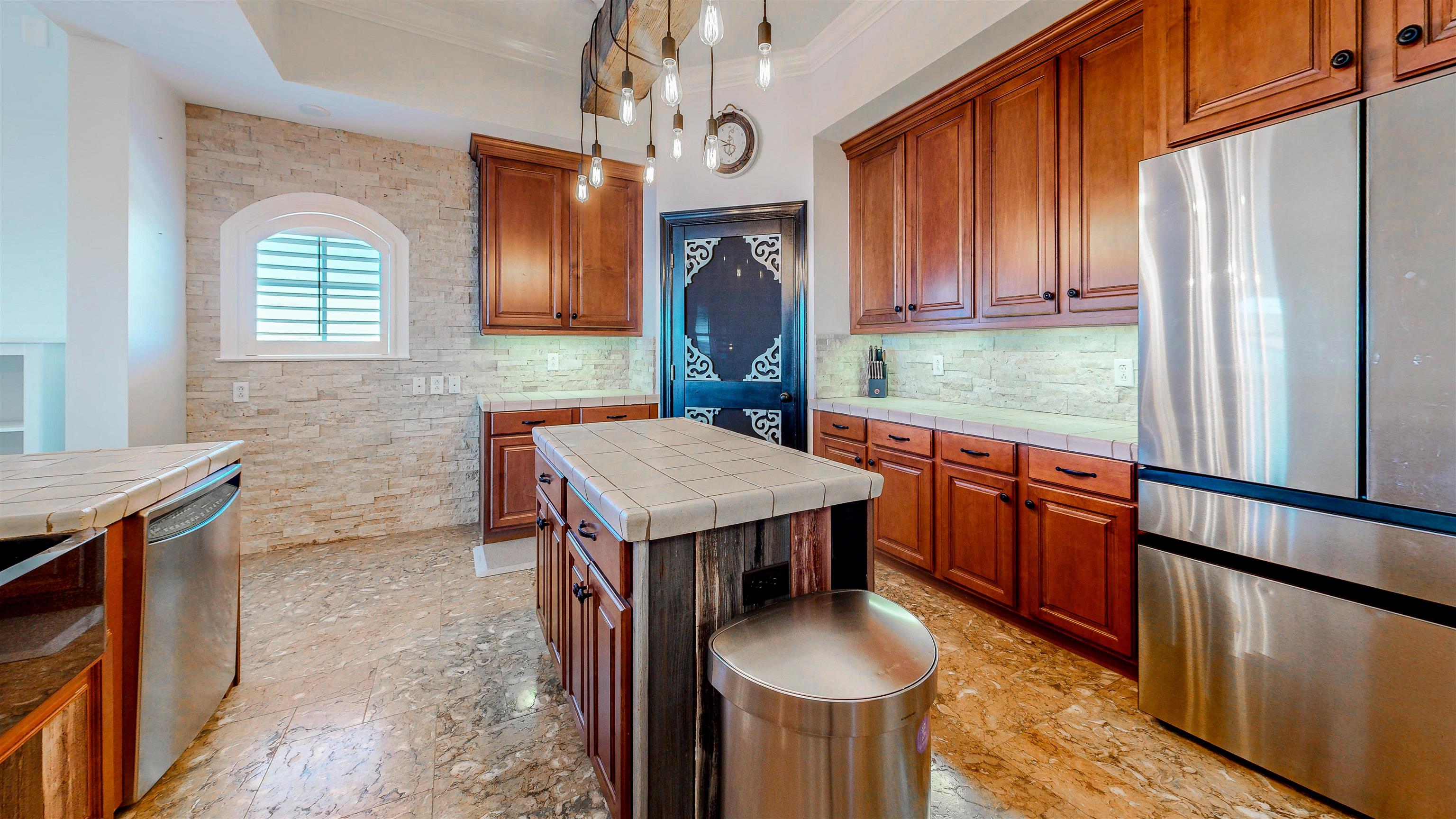 115 Sunset Harbor Way, Unit 303 St. Augustine, FL 32080 - Photo 22 of 76 a kitchen with stainless steel appliances granite countertop a sink a stove and a wooden floors