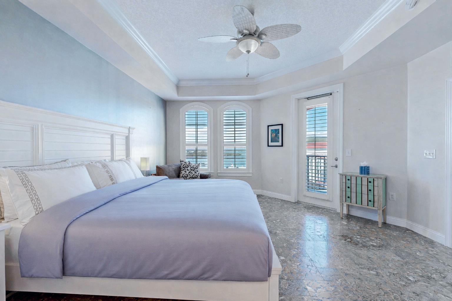 115 Sunset Harbor Way, Unit 303 St. Augustine, FL 32080 - Photo 24 of 76 a spacious bedroom with a large bed chandelier and a window