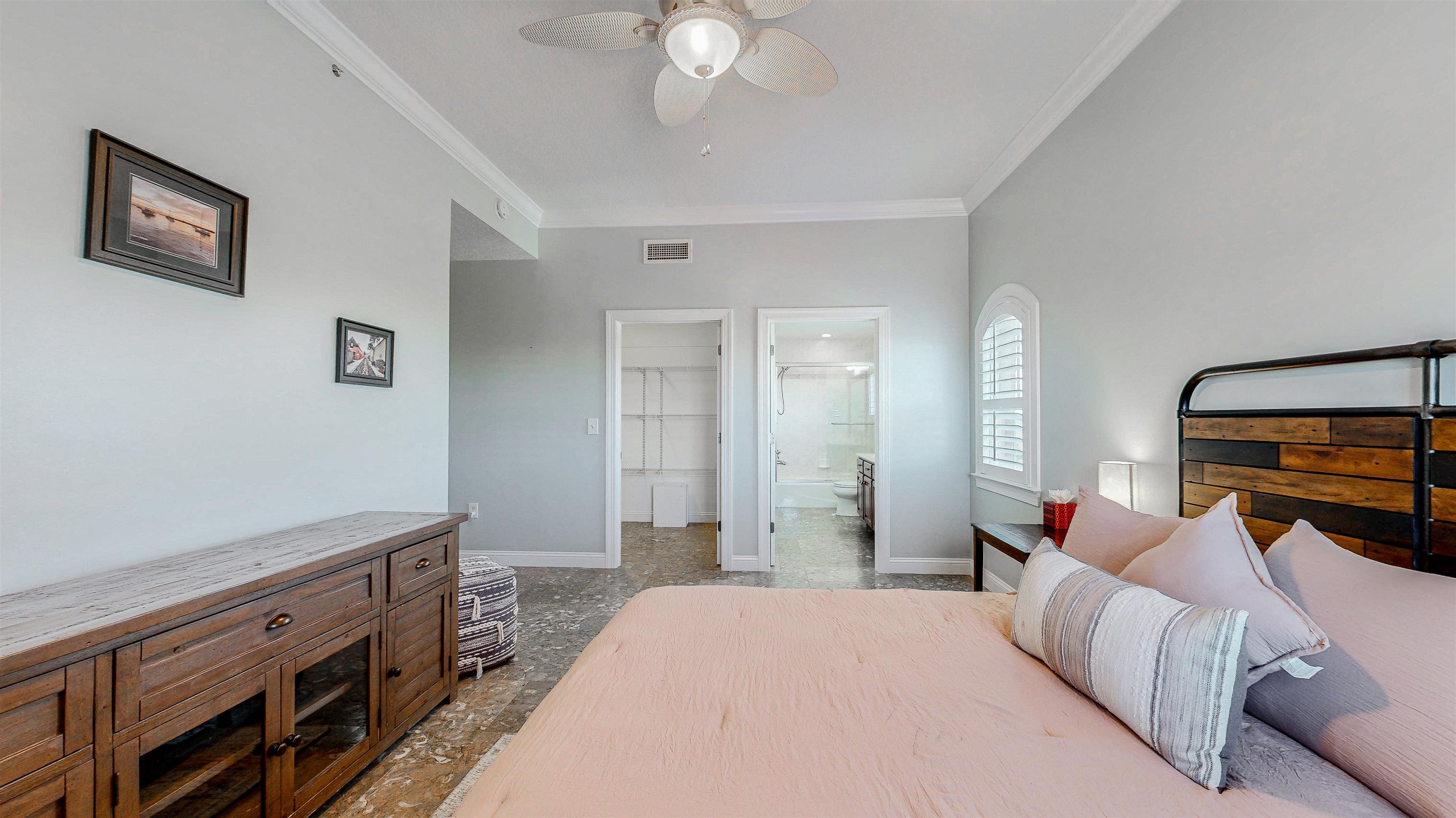 115 Sunset Harbor Way, Unit 303 St. Augustine, FL 32080 - Photo 38 of 76 a bedroom with a bed and a chandelier