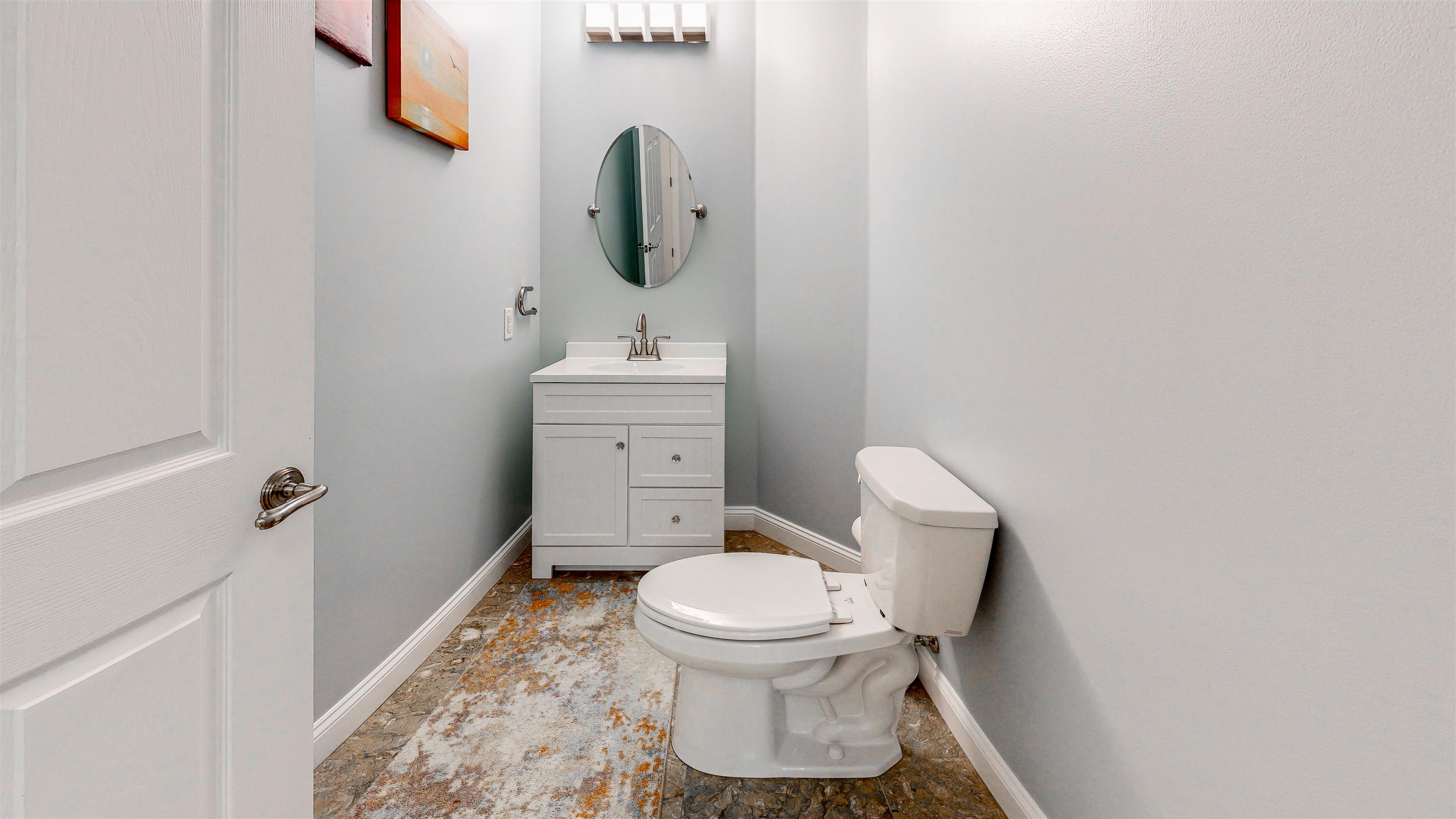 115 Sunset Harbor Way, Unit 303 St. Augustine, FL 32080 - Photo 48 of 76 a white toilet sitting next to a sink and vanity