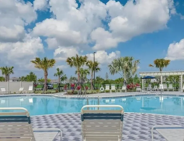 a living room with furniture a dining table and kitchen view