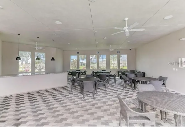 a kitchen with granite countertop a refrigerator sink and stove