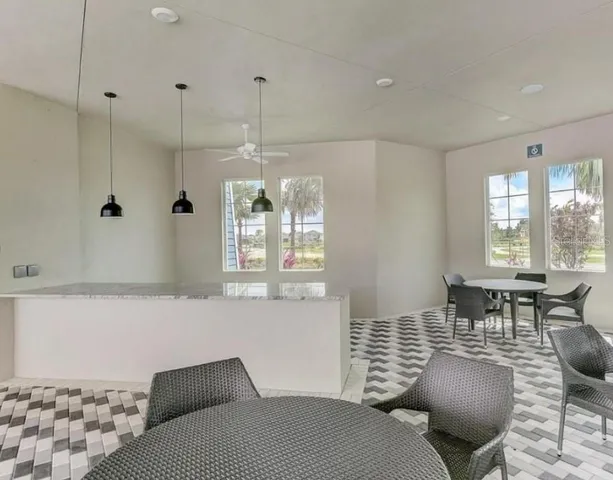 a kitchen with granite countertop a refrigerator and a sink