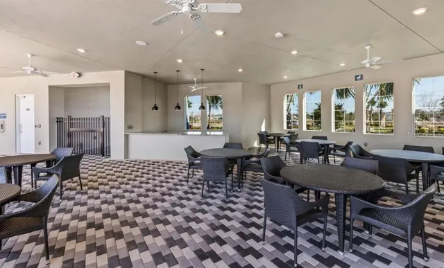 a kitchen with stainless steel appliances granite countertop a stove a sink and white cabinets