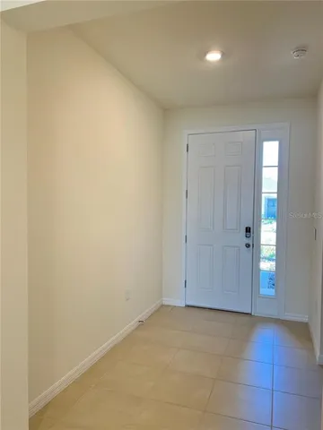 a kitchen with stainless steel appliances granite countertop a stove a sink a refrigerator a microwave and white cabinets