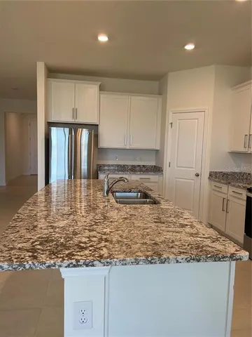 a kitchen with stainless steel appliances granite countertop a stove and a refrigerator