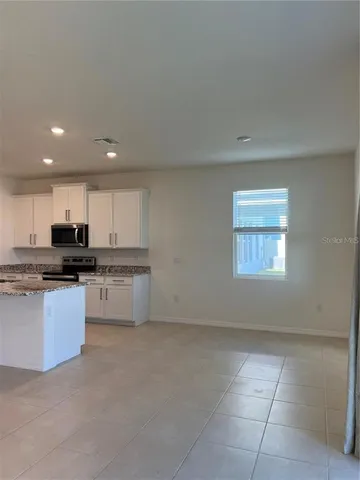 a bathroom with a granite countertop sink and vanity