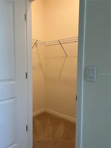 a bathroom with a granite countertop sink toilet mirror and bathtub