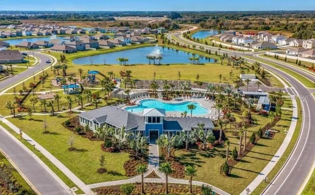 a view of a house with swimming pool and sitting area