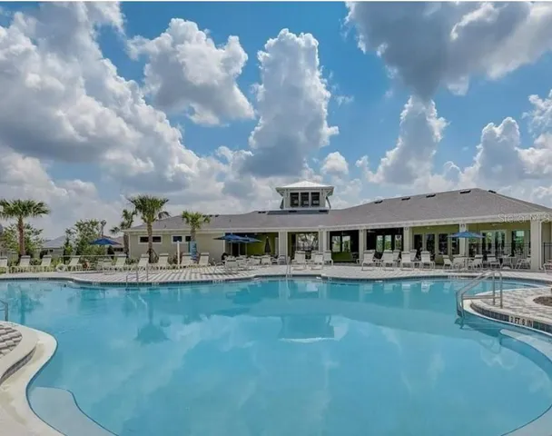 a bedroom with furniture and a large window