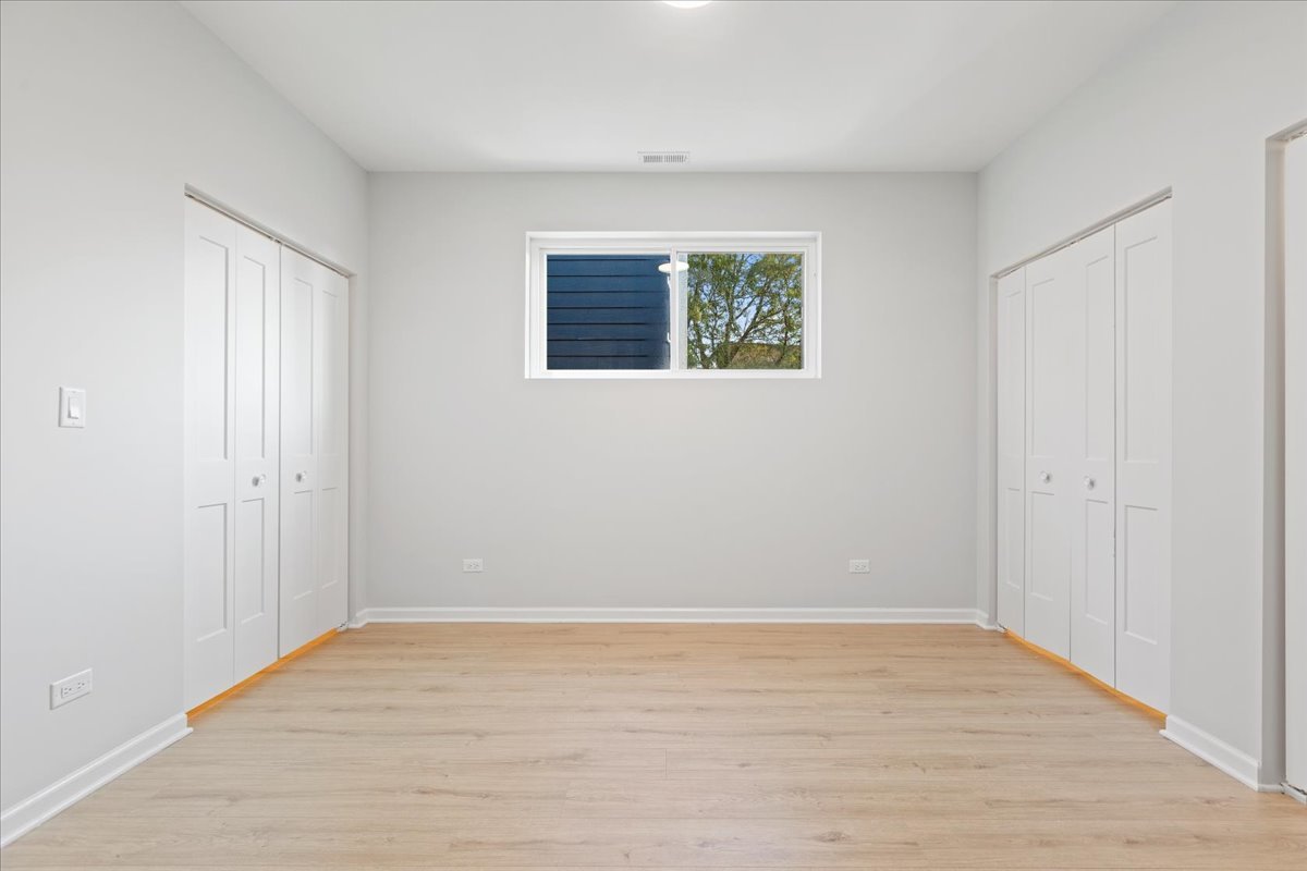 4537 South Evans Avenue, Unit 1B Chicago, IL 60653 - Photo 5 of 7 a view of an empty room with wooden floor